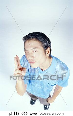 Man pointing two fingers, high angle view View Large Photo Image Stock Photography - Man pointing two fingers, high angle view. Fotosearch