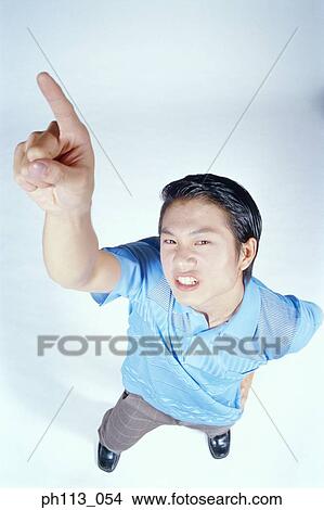 Man pointing up, high angle view View Large Photo Image Picture - Man pointing up, high angle view. Fotosearch