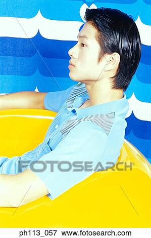Man sitting on ball chair, profile View Large Photo Image Stock Photo - Man sitting on ball chair, profile. Fotosearch