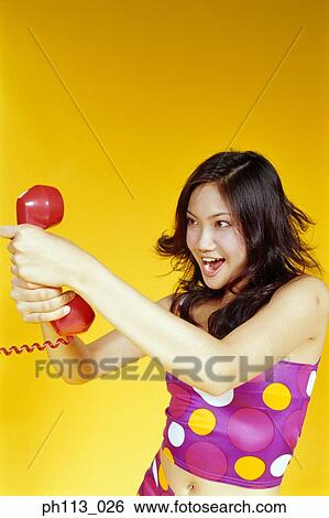 Stock Photograph - Woman is 'strangling' the handset. Fotosearch