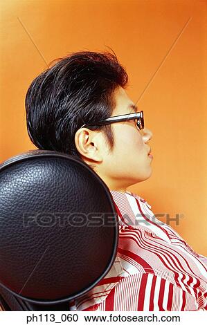Young man relaxing on leather couch, profile View Large Photo Image Stock Image - Young man relaxing on leather couch, profile. Fotosearch