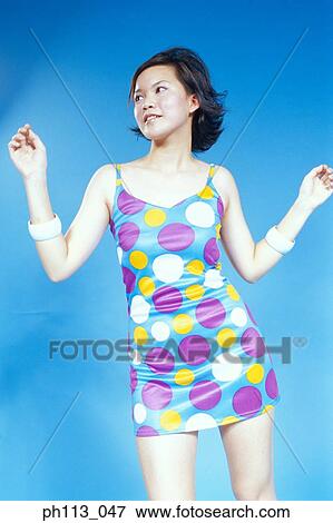 Stock Photo - Young woman in polka dot blouse, portrait. Fotosearch