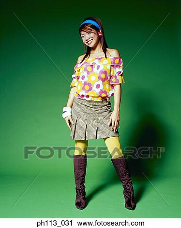 Young woman in sporty floral blouse and short shirt, smiling View Large Photo Image Stock Image - Young woman in sporty floral blouse and short shirt, smiling. Fotosearch