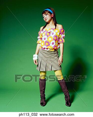 Young woman in sporty floral blouse and short shirt, smiling View Large Photo Image Stock Image - Young woman in sporty floral blouse and short shirt, smiling. Fotosearch