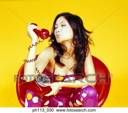 Young woman kissing handset, profile View Large Photo Image Stock Image - Young woman kissing handset, profile . Fotosearch