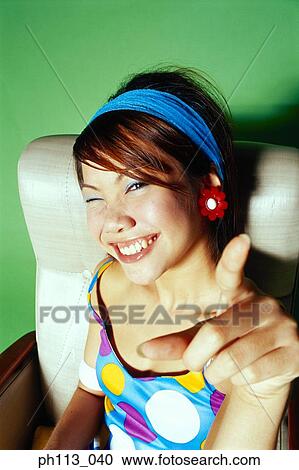 Young woman pointing finger, portrait View Large Photo Image Stock Image - Young woman pointing finger, portrait . Fotosearch