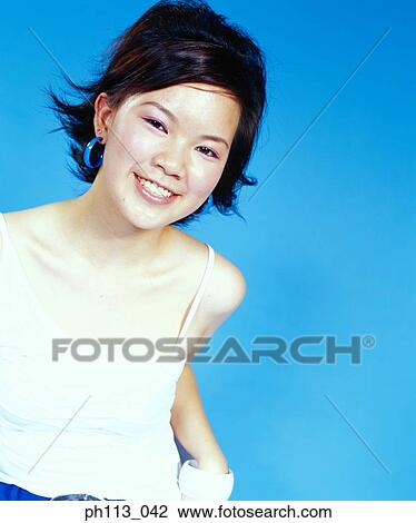 Young woman smiling, portrait View Large Photo Image Stock Image - Young woman smiling, portrait . Fotosearch
