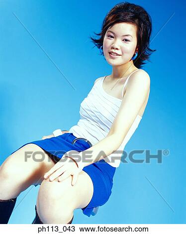 Stock Image - Young woman smiling, portrait . Fotosearch