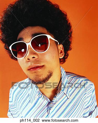 Man with afro hair, wearing sunglasses, portrait View Large Photo Image Stock Image - Man with afro hair, wearing sunglasses, portrait. Fotosearch