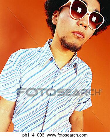 Man with afro hair, wearing sunglasses, portrait View Large Photo Image Stock Image - Man with afro hair, wearing sunglasses, portrait. Fotosearch