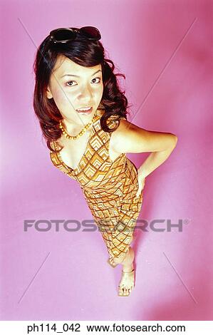 Portrait of a young woman posing, high angle view View Large Photo Image Stock Image - Portrait of a young woman posing, high angle view. Fotosearch