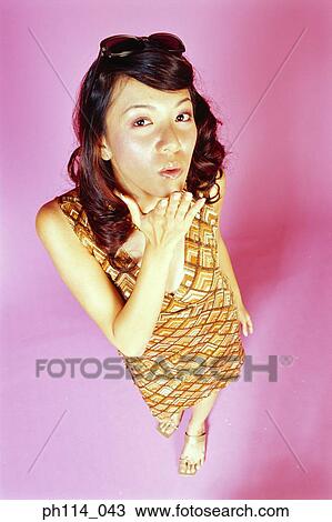 Portrait of a young woman posing, high angle view View Large Photo Image Stock Image - Portrait of a young woman posing, high angle view. Fotosearch