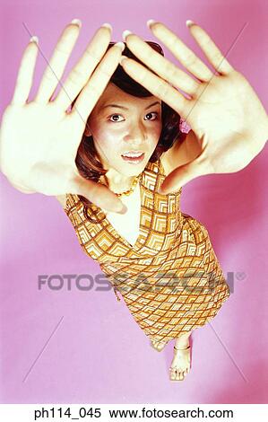 Portrait of a young woman posing, high angle view View Large Photo Image Stock Photography - Portrait of a young woman posing, high angle view. Fotosearch