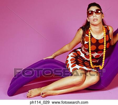 Portrait of a young woman wearing sunglass View Large Photo Image Stock Photo - Portrait of a young woman wearing sunglass. Fotosearch