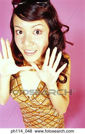 Stock Photo - Woman with her eyes open wide, surprised look. Fotosearch