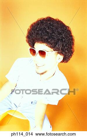 Young Asian male with afro hair in sitting on ball chair View Large Photo Image Picture - Young Asian male with afro hair in sitting on ball chair. Fotosearch