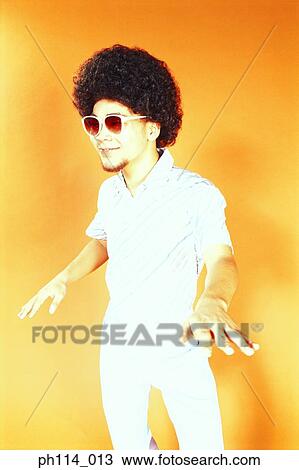 Young Asian male with afro hair in dancing pose View Large Photo Image Stock Image - Young Asian male with afro hair in dancing pose. Fotosearch