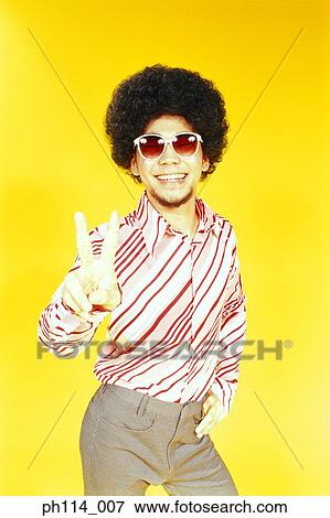 Stock Photo - Young Asian male with afro hair in dancing pose. Fotosearch