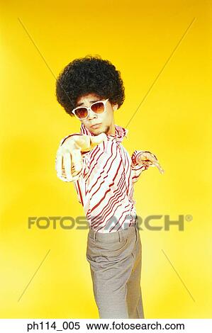 Stock Photography - Young Asian male with afro hair in dancing pose. Fotosearch