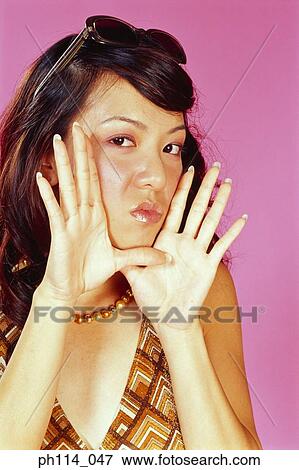 Young woman gossiping, close-up View Large Photo Image Stock Photo - Young woman gossiping, close-up. Fotosearch