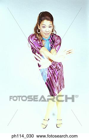 Young woman in dancing pose View Large Photo Image Stock Image - Young woman in dancing pose. Fotosearch