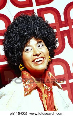Stock Photography - Portrait of a woman smiling with an Afro . Fotosearch