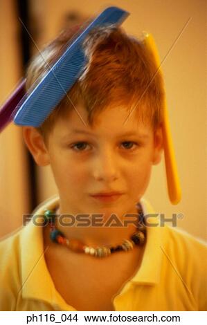 Combs stuck on boy's hair View Large Photo Image Picture - Combs stuck on boy's hair. Fotosearch
