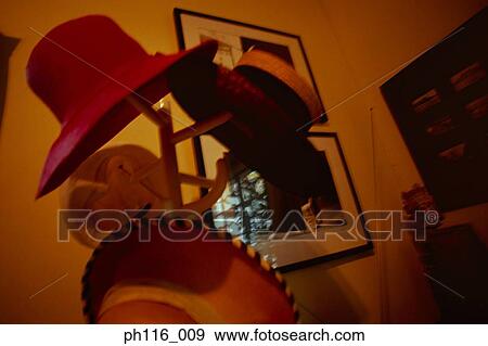 Stock Photo - Hats hanging on hat stand. Fotosearch