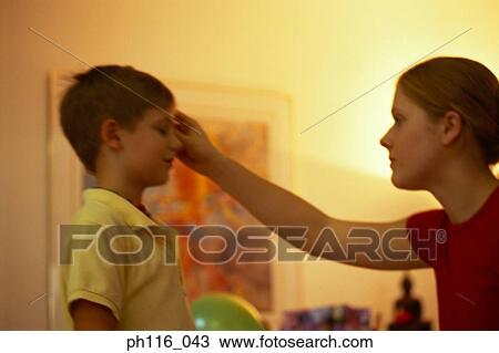 Stock Image - Mother cleaning son's head. Fotosearch