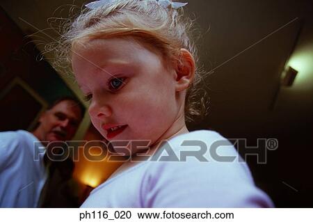 Side profile of young girl, Father in background View Large Photo Image Stock Image - Side profile of young girl, Father in background. Fotosearch