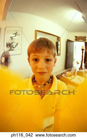 Young boy holding yellow balloons View Large Photo Image Stock Image - Young boy holding yellow balloons. Fotosearch