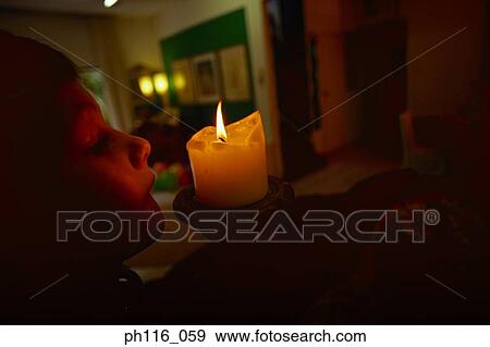 Young boy looking at burning candle View Large Photo Image Stock Photo - Young boy looking at burning candle. Fotosearch