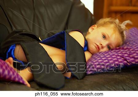 Young girl lying on sofa, sulking View Large Photo Image Stock Photography - Young girl lying on sofa, sulking. Fotosearch