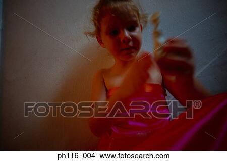 Young girl on stairs in pink costume playing with toy View Large Photo Image Picture - Young girl on stairs in pink costume playing with toy. Fotosearch