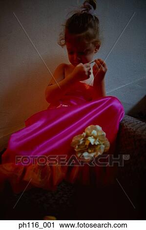 Stock Image - Young girl on stairs in pink costume . Fotosearch
