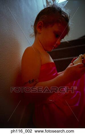 Young girl on stairs in pink costume View Large Photo Image Stock Image - Young girl on stairs in pink costume . Fotosearch