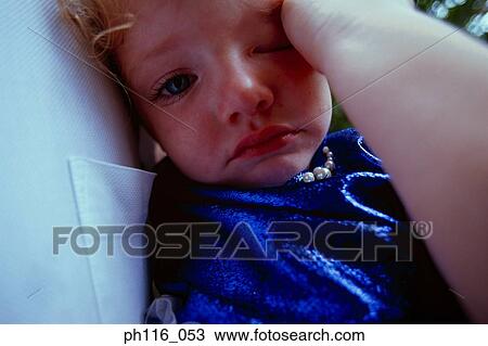 Young girl rubbing her eyes View Large Photo Image Stock Image - Young girl rubbing her eyes. Fotosearch