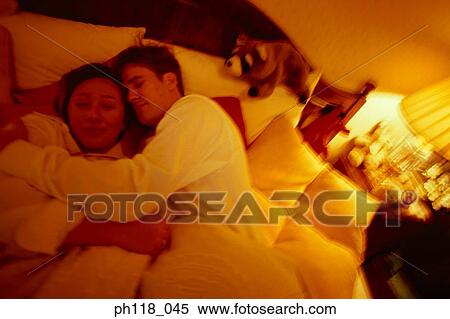 Stock Photography - Couple on bed, Spooning . Fotosearch