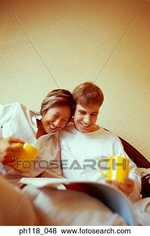 Couple on bed View Large Photo Image Stock Photo - Couple on bed. Fotosearch