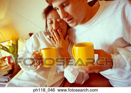 Stock Photograph - Couple on bed. Fotosearch