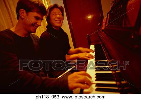 Couple playing piano View Large Photo Image Stock Image - Couple playing piano. Fotosearch