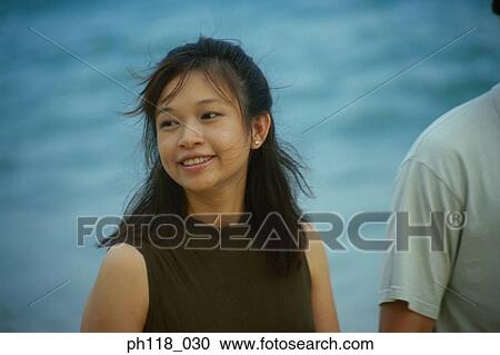 Couple walking along beach View Large Photo Image Stock Image - Couple walking along beach. Fotosearch