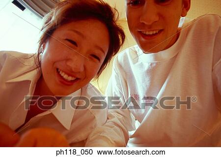 Portrait of a young couple, smiling View Large Photo Image Stock Image - Portrait of a young couple, smiling. Fotosearch