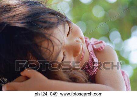 Stock Photo - Portrait of a young Asian girl, resting. Fotosearch