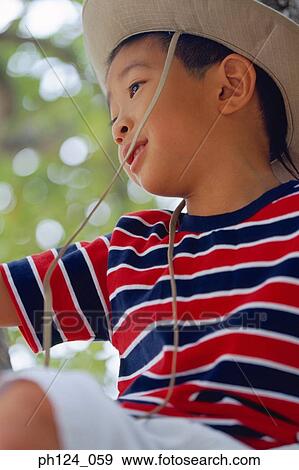 Young Asian boy wearing hat, close-up View Large Photo Image Stock Photo - Young Asian boy wearing hat, close-up. Fotosearch