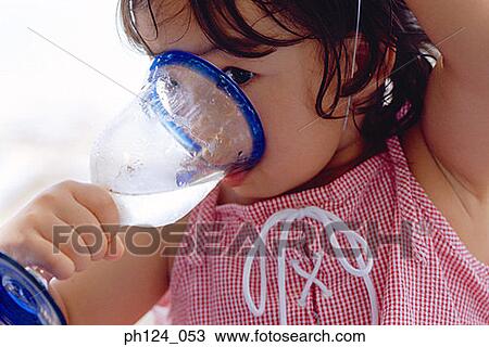Young Asian girl drinking water from glass View Large Photo Image Stock Image - Young Asian girl drinking water from glass. Fotosearch