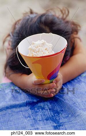 Young Asian girl holding a party hat, head down View Large Photo Image Stock Image - Young Asian girl holding a party hat, head down. Fotosearch