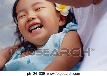 Young Asian girl laughing in father's arms View Large Photo Image Stock Photo - Young Asian girl laughing in father's arms. Fotosearch