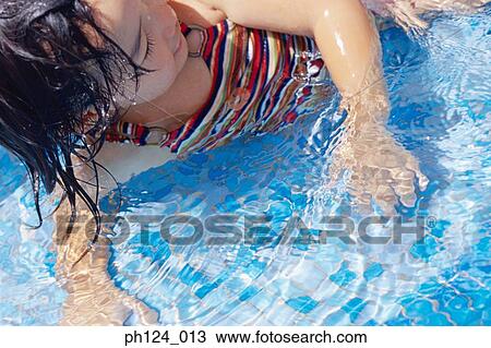 Stock Image - Young girl in the pool. Fotosearch