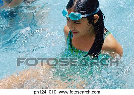 Young girl in the pool, swimming goggles on her head View Large Photo Image Stock Image - Young girl in the pool, swimming goggles on her head. Fotosearch